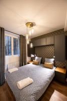 Posteľ alebo postele v izbe v ubytovaní La Suite Sépia - Superbe appartement Vieux Lyon