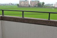 a rail on top of a wall with a green field at Yilan My House Homestay B&amp;B in Dayin