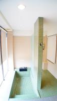 a bathroom with a shower with green tiles at Lan Yang Resort Four Seasons in Dongshan