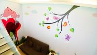a childs room with a wall with flowers and butterflies at Lan Yang Resort Four Seasons in Dongshan