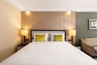 A bed or beds in a room at Kempinski Hotel Corvinus Budapest