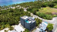 an aerial view of a resort with palm trees and the ocean at Maa Thundi in Fuvahmulah