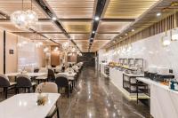 a restaurant with white tables and chairs in a room at Atour Hotel Suzhou Guanqian Street in Suzhou
