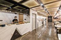 a man wearing a face mask in a restaurant kitchen at Atour Hotel Suzhou Guanqian Street in Suzhou