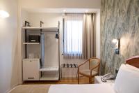A bed or beds in a room at Hotel Dei Congressi