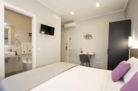 A bed or beds in a room at Affittacamere Orchidea for Tourists Hesperia Hosp