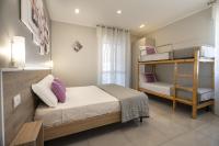 A bed or beds in a room at Affittacamere Orchidea for Tourists Hesperia Hosp