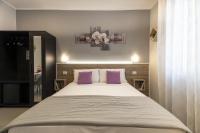 A bed or beds in a room at Affittacamere Orchidea for Tourists Hesperia Hosp