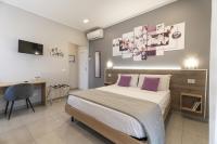 A bed or beds in a room at Affittacamere Orchidea for Tourists Hesperia Hosp