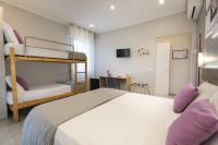 A bed or beds in a room at Affittacamere Orchidea for Tourists Hesperia Hosp