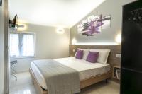 A bed or beds in a room at Affittacamere Orchidea for Tourists Hesperia Hosp