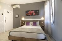 A bed or beds in a room at Affittacamere Orchidea for Tourists Hesperia Hosp