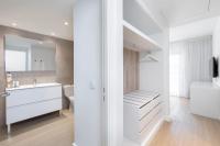 a white bathroom with a sink and a toilet at Sol Fuerteventura Jandia - All Suites in Morro del Jable