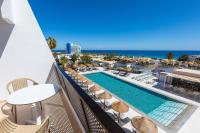 a view of the pool and beach from the balcony of a hotel at Sol Fuerteventura Jandia - All Suites in Morro del Jable