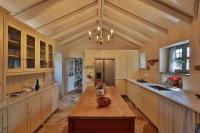 a large kitchen with a table and a chandelier at KATIKIA ZAGORI in Vitsa