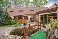 a house with a walkway leading to a garden at Platan Garden Rooms & Restaurant in Hajdúszoboszló