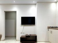 TV a/nebo společenská místnost v ubytování El Lotus Building