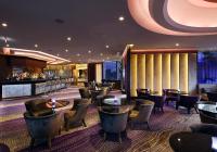 a restaurant with tables and chairs and a bar at Four Seasons Hotel in Limassol