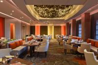 a restaurant with tables and chairs and a chandelier at Four Seasons Hotel in Limassol