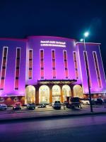 un edificio rosa con coches estacionados frente a él en الجوهرة بارك 4, en Hafr Al Batin