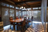 Un comedor con mesa y sillas de madera. en 長峰荘, en Azumino