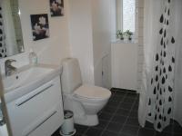a white bathroom with a toilet and a sink at Aalborg City Rooms ApS in Aalborg