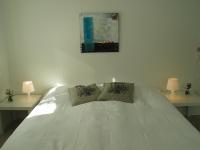 a bedroom with a white bed with two lamps at Aalborg City Rooms ApS in Aalborg