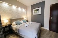 Posteľ alebo postele v izbe v ubytovaní Apartamenty City Center - Zdrojowe