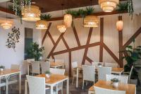 a dining room with tables and chairs and lights at Anam Beach Resort in Calatagan