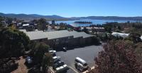 an aerial view of a building with a parking lot at Acacia Snowy Motel in Jindabyne