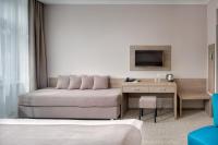 a living room with a couch and a television at Hotel Florenc in Prague