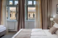 a bedroom with a bed and a large window at Hotel Florenc in Prague