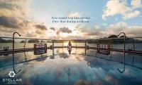 a woman standing on the edge of a pool with the sunset at Stellar of the Seas Cruise in Ha Long