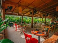 ein Restaurant mit Holztischen und -stühlen und Fenstern in der Unterkunft Oaga Art Resort Maldives - Greatest All Inclusive Plan in Nord-Malé-Atoll