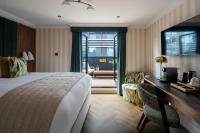 a hotel room with a bed and a desk at The Chamberlain in London