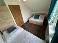 Posteľ alebo postele v izbe v ubytovaní Delfinek - Domki Apartamenty