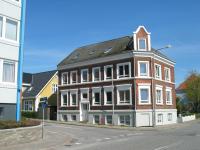 a brown and white building on the corner of a street at Aalborg City Rooms ApS in Aalborg
