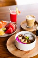 a table with a bowl of rice and a plate of fruit at Uryah Hotel Lombok in Selong Belanak