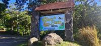 a sign for a bluebonneau motel with a rock at Hotel Claro de Luna in Monteverde Costa Rica