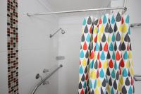 a bathroom with a shower curtain with colorful dots at Acacia Snowy Motel in Jindabyne