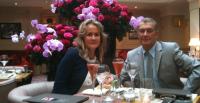 a man and woman sitting at a table with wine glasses at B&amp;B Château de Preuil in Vallenay