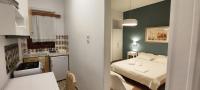 A bed or beds in a room at Papadioti Apartments