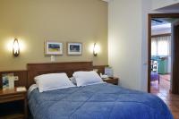 A bed or beds in a room at Sissy Village All Suite Hotel