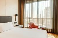 A bed or beds in a room at Sercotel Sorolla Palace