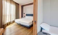 A bed or beds in a room at Sercotel Sorolla Palace
