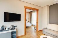 A television and/or entertainment centre at Sercotel Sorolla Palace