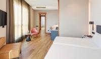 A bed or beds in a room at Sercotel Sorolla Palace