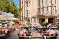 a patio with tables and chairs in front of a building at NH Collection Helsinki Grand Hansa in Helsinki