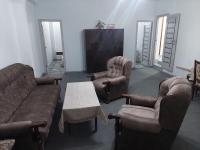 a living room with a couch and chairs and a tv at Suny Sevan in Sevan