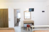 a bedroom with a desk with a mirror and a stool at George Studios in Naxos Chora